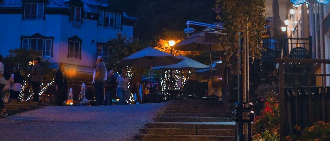 The street outside, lamplight after dark