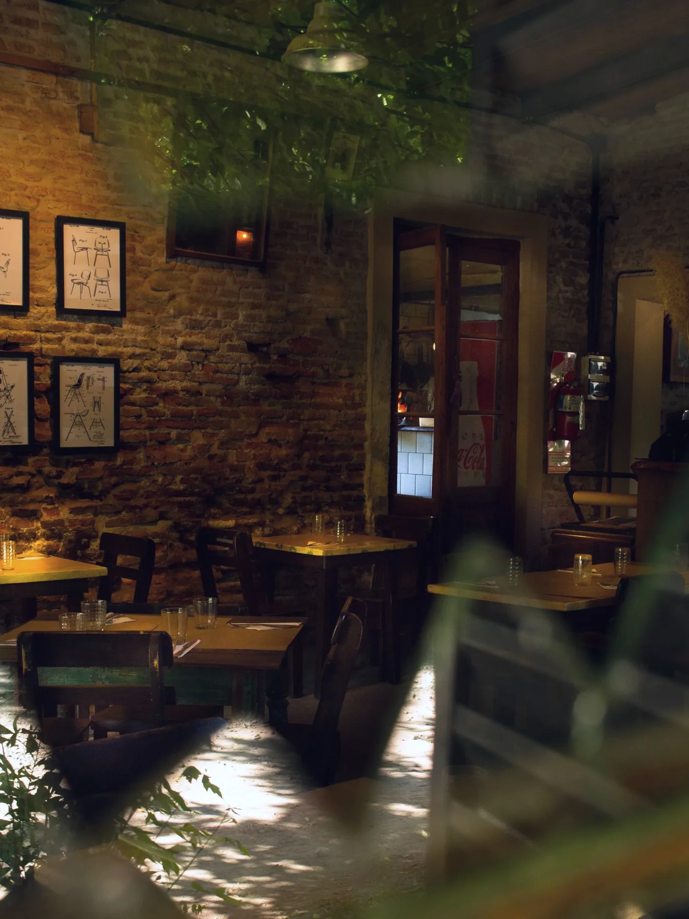 Timber tables set under brick and low light