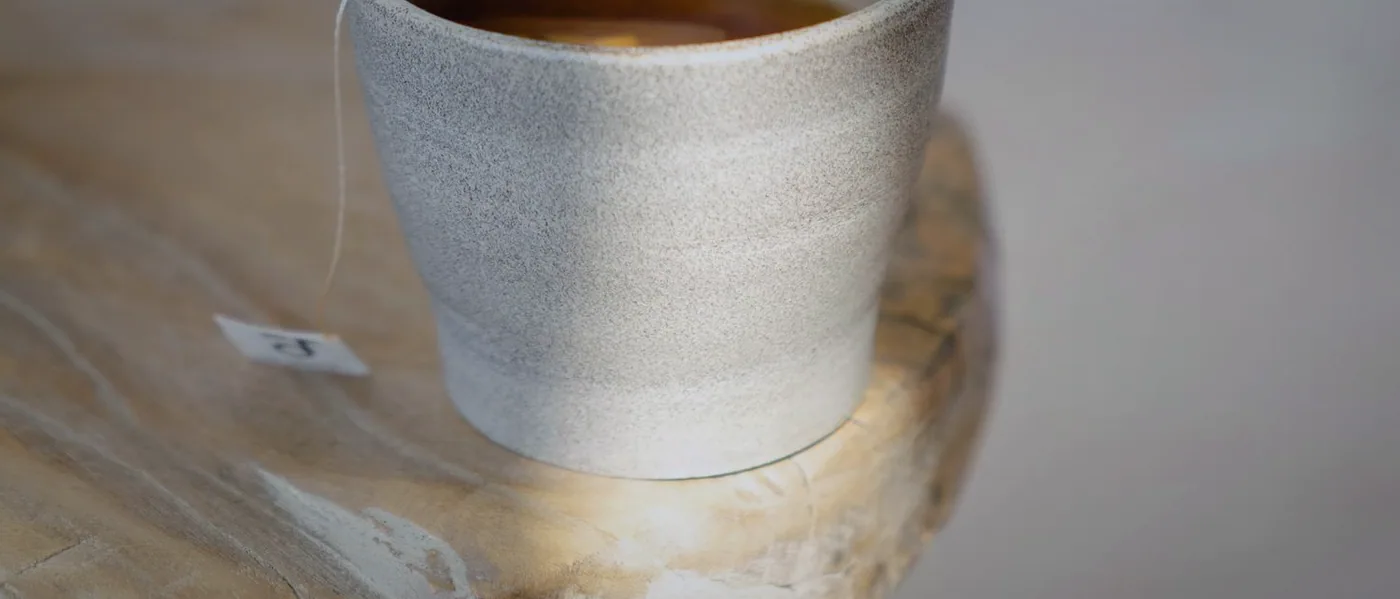 A cup of tea left to steep on the counter